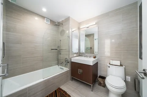a bathroom with a toilet a sink and bathtub