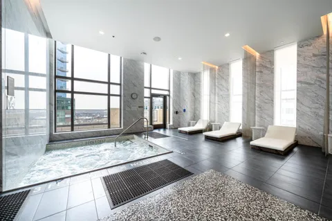 a lobby with furniture and floor to ceiling window