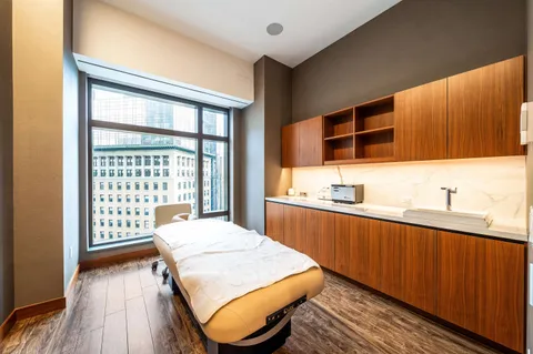 a kitchen with a table chairs sink and wooden floor