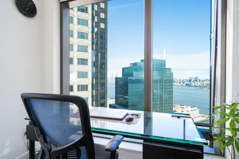 a view of a dining room with furniture and window