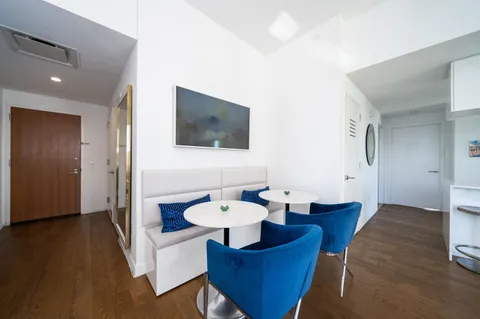 a dining room with furniture and wooden floor