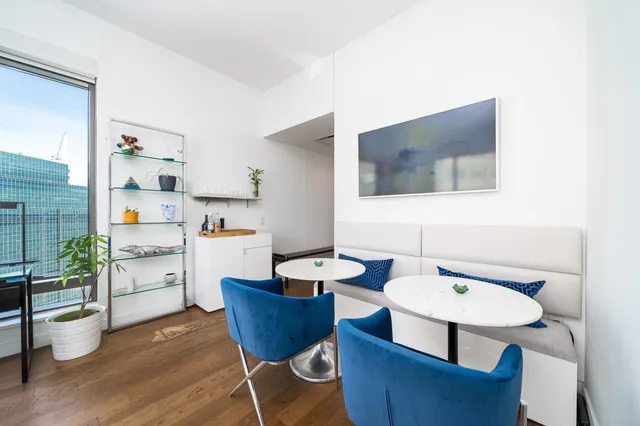 a dining room with furniture and wooden floor