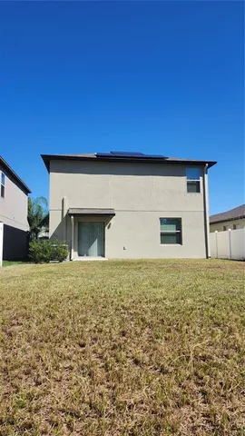 a view of backyard of house and garage