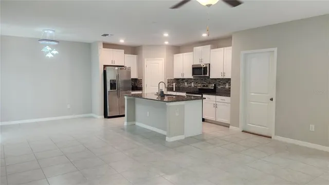 a kitchen with stainless steel appliances a refrigerator sink and cabinets