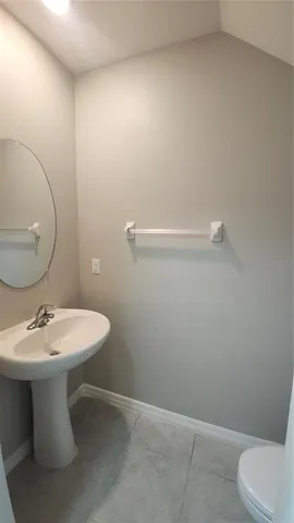 a bathroom with a sink mirror and toilet