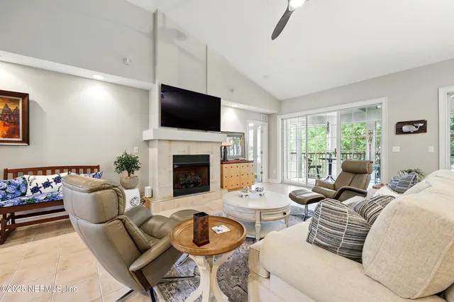 a kitchen with a table chairs microwave and cabinets