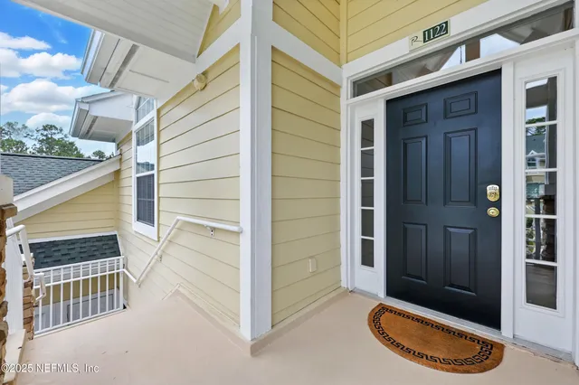 a view of a porch with wooden floor and a window