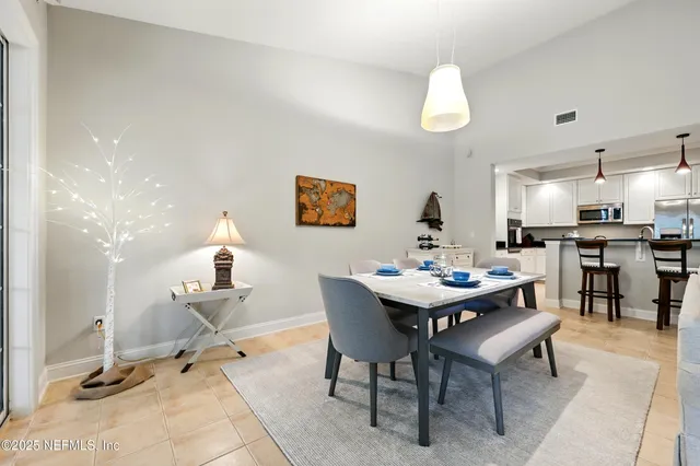 a living room with fireplace furniture and a chandelier