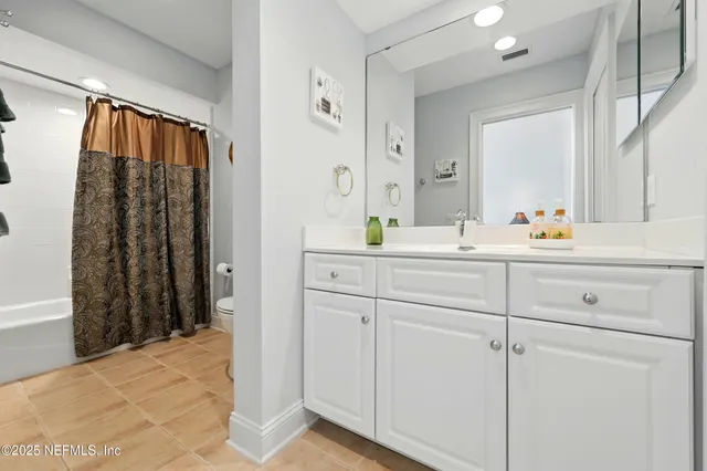 a bathroom with a sink vanity mirror and toilet