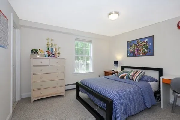 a spacious bedroom with a bed and a window