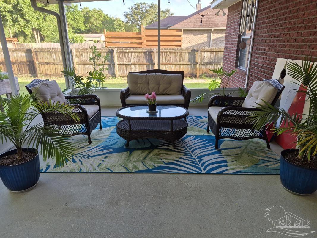 1960 Amhurst Court Navarre, FL 32566 - Photo 14 of 47 a living room with furniture and a floor to ceiling window