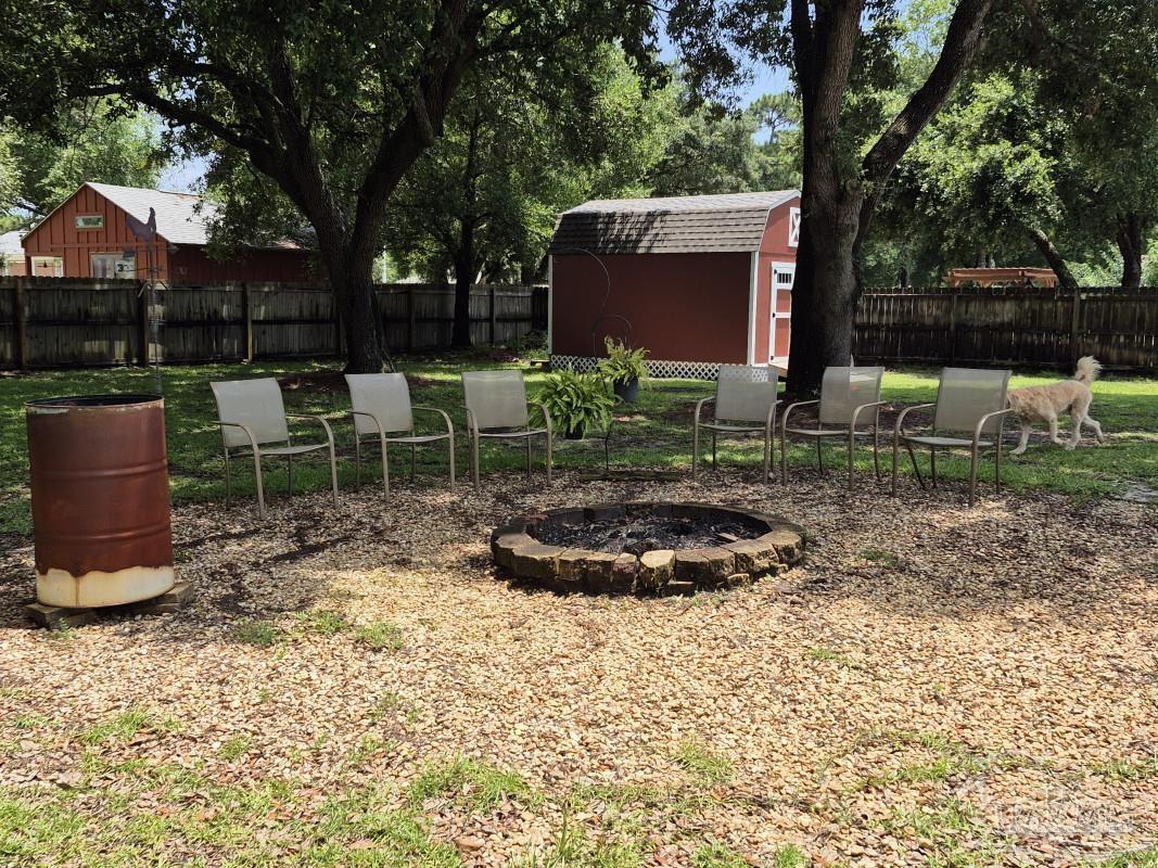 1960 Amhurst Court Navarre, FL 32566 - Photo 19 of 47 a backyard of a house with table and chairs