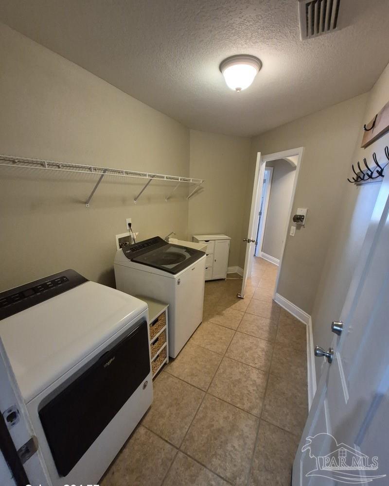 1960 Amhurst Court Navarre, FL 32566 - Photo 23 of 47 a utility room with dryer and washer