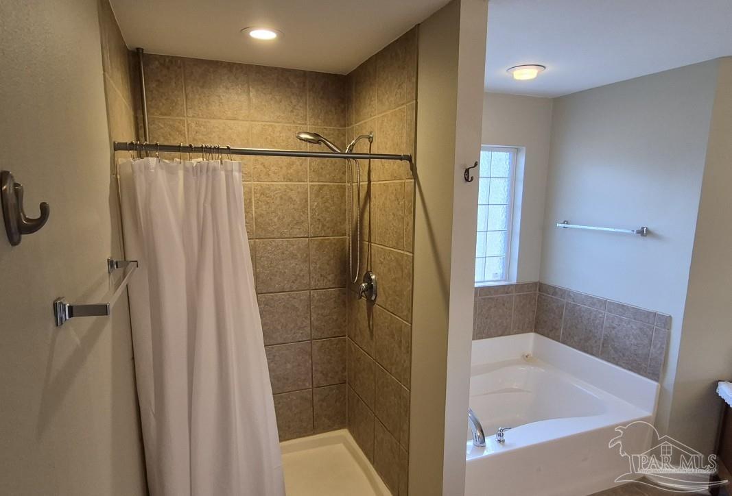 1960 Amhurst Court Navarre, FL 32566 - Photo 29 of 47 a bathroom with a shower and a tub