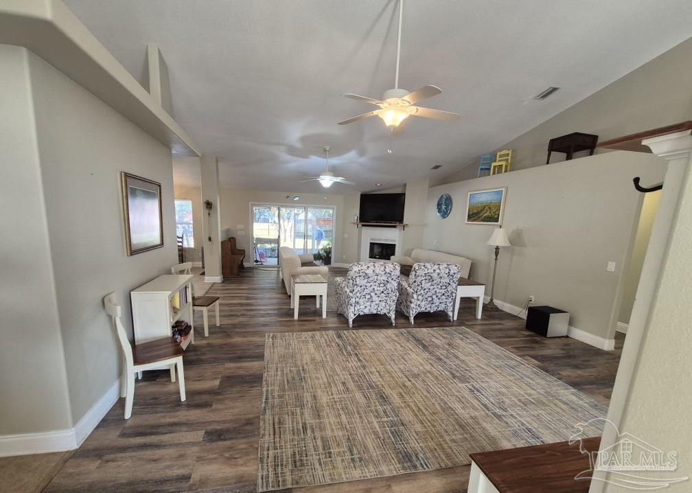 1960 Amhurst Court Navarre, FL 32566 - Photo 3 of 47 a living room with furniture and a chandelier