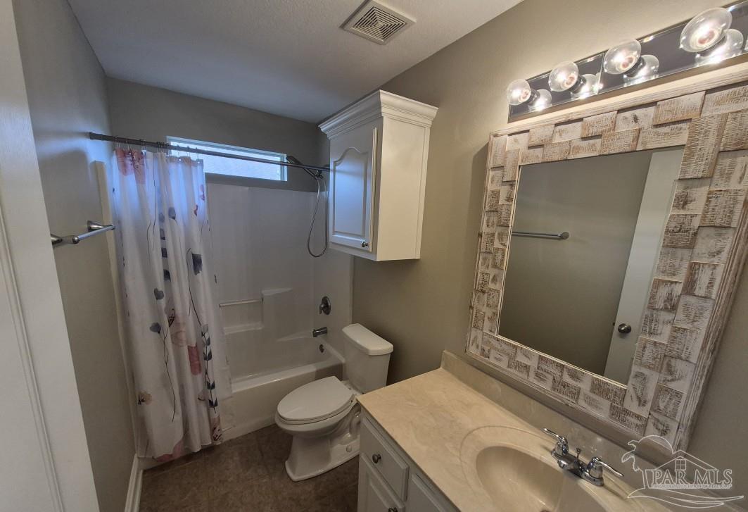 1960 Amhurst Court Navarre, FL 32566 - Photo 33 of 47 a bathroom with a sink a toilet and shower