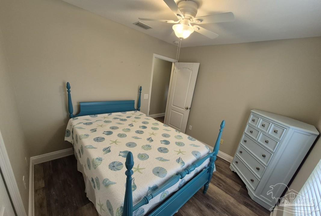 1960 Amhurst Court Navarre, FL 32566 - Photo 34 of 47 a bedroom with a bed and a mirror