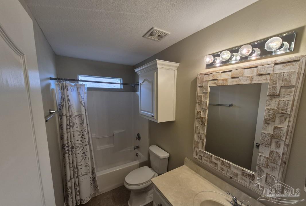 1960 Amhurst Court Navarre, FL 32566 - Photo 35 of 47 a bathroom with a sink a toilet and shower