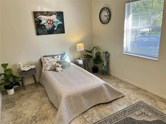 a bedroom with a bed and window