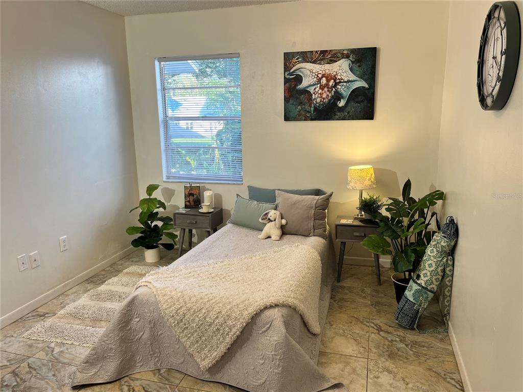 740 East Pearl Street, Unit C Bartow, FL 33830 - Photo 15 of 20 a bedroom with bed and paintings on the wall