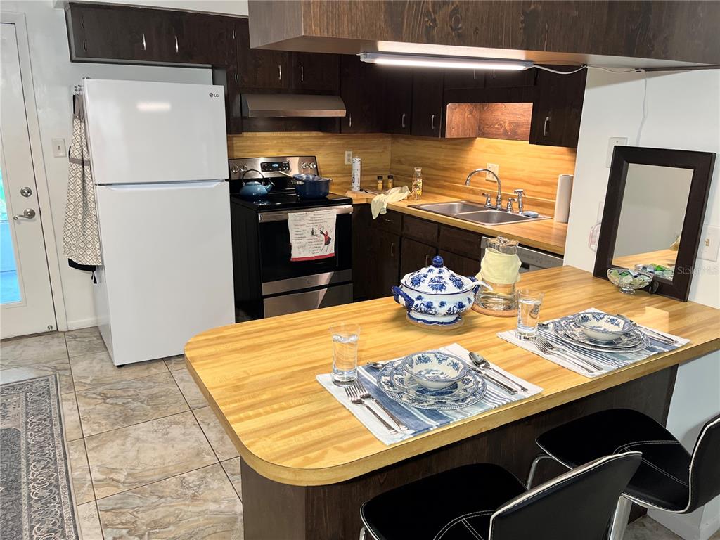 740 East Pearl Street, Unit C Bartow, FL 33830 - Photo 9 of 20 a kitchen with stainless steel appliances granite countertop a sink stove and refrigerator