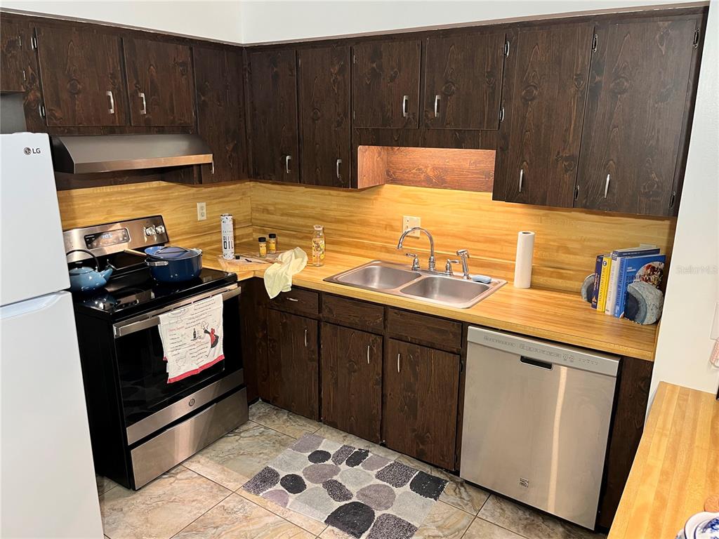 740 East Pearl Street, Unit C Bartow, FL 33830 - Photo 10 of 20 a kitchen with stainless steel appliances a stove a sink and a microwave