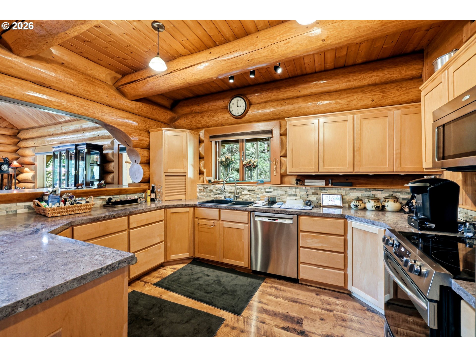 390 Spruce Creek Road Longview, WA 98632 - Photo 20 of 45 a kitchen with stainless steel appliances granite countertop a sink and cabinets