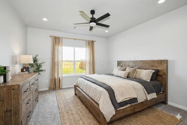 a view of a big room with a ceiling fan