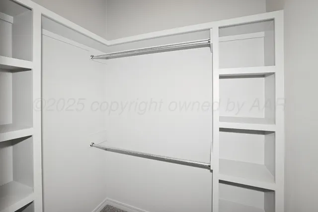 a bedroom with a large bed and a potted plant