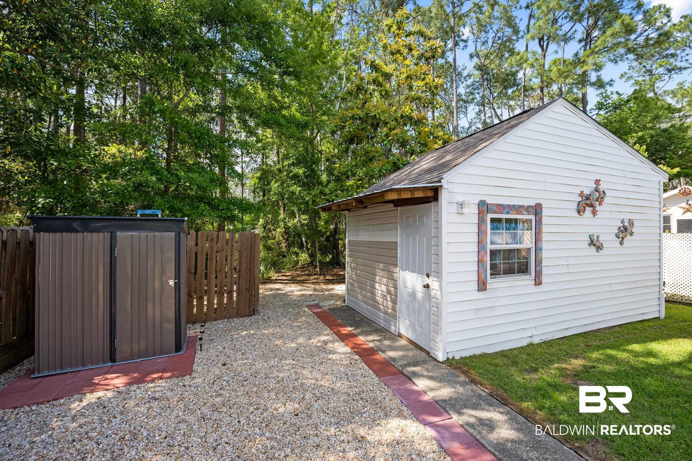183 Defuniak Loop Lillian, AL 36549 - Photo 22 of 46 Garage with a shed and fence