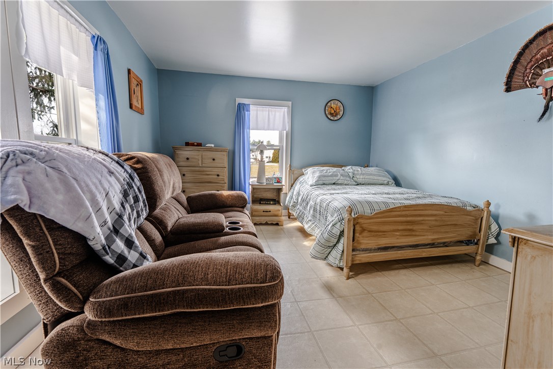 16350 Nauvoo Road Middlefield, OH 44062 - Photo 30 of 50 Bedroom with light tile patterned flooring and baseboards