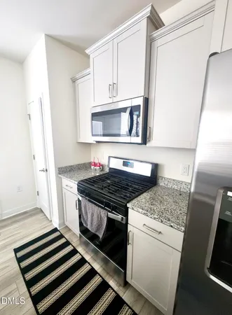 a kitchen with a stove and a microwave