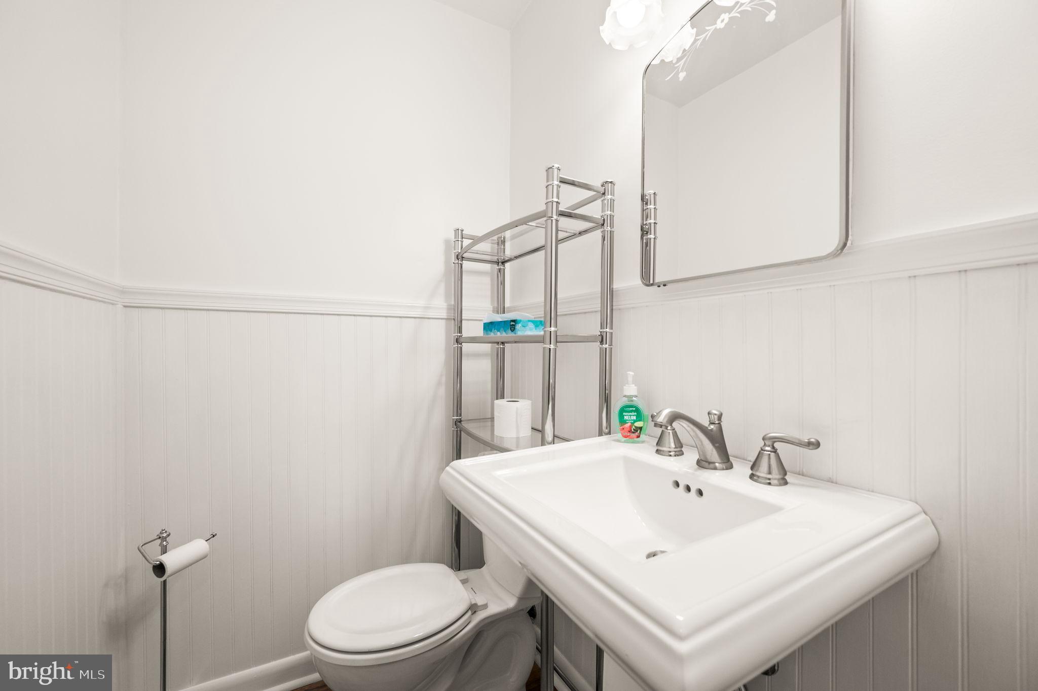 1565 Parklane Road Swarthmore, PA 19081 - Photo 13 of 28 a bathroom with a sink a toilet and mirror