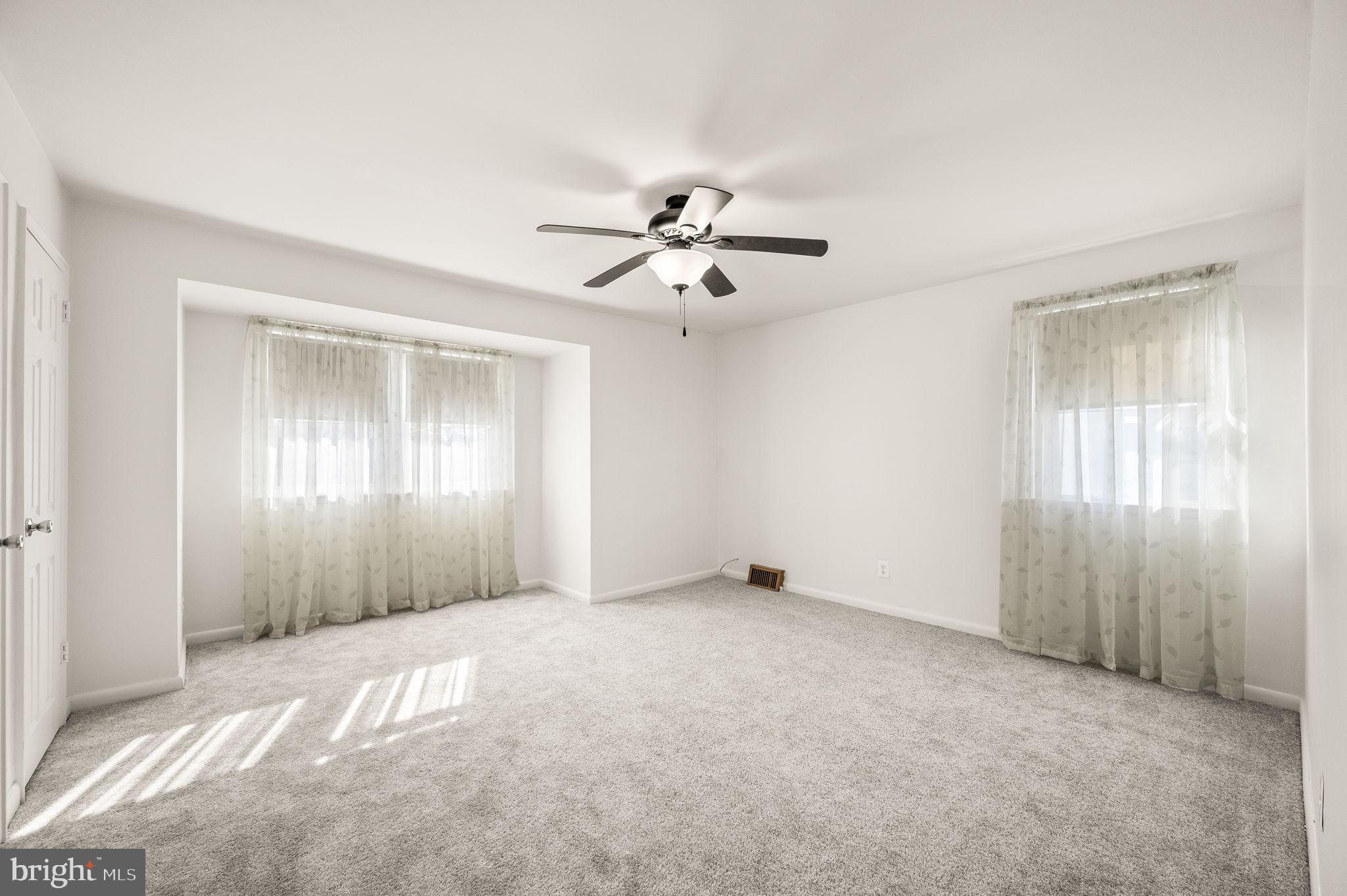 1565 Parklane Road Swarthmore, PA 19081 - Photo 15 of 28 a view of an empty room with a ceiling fan
