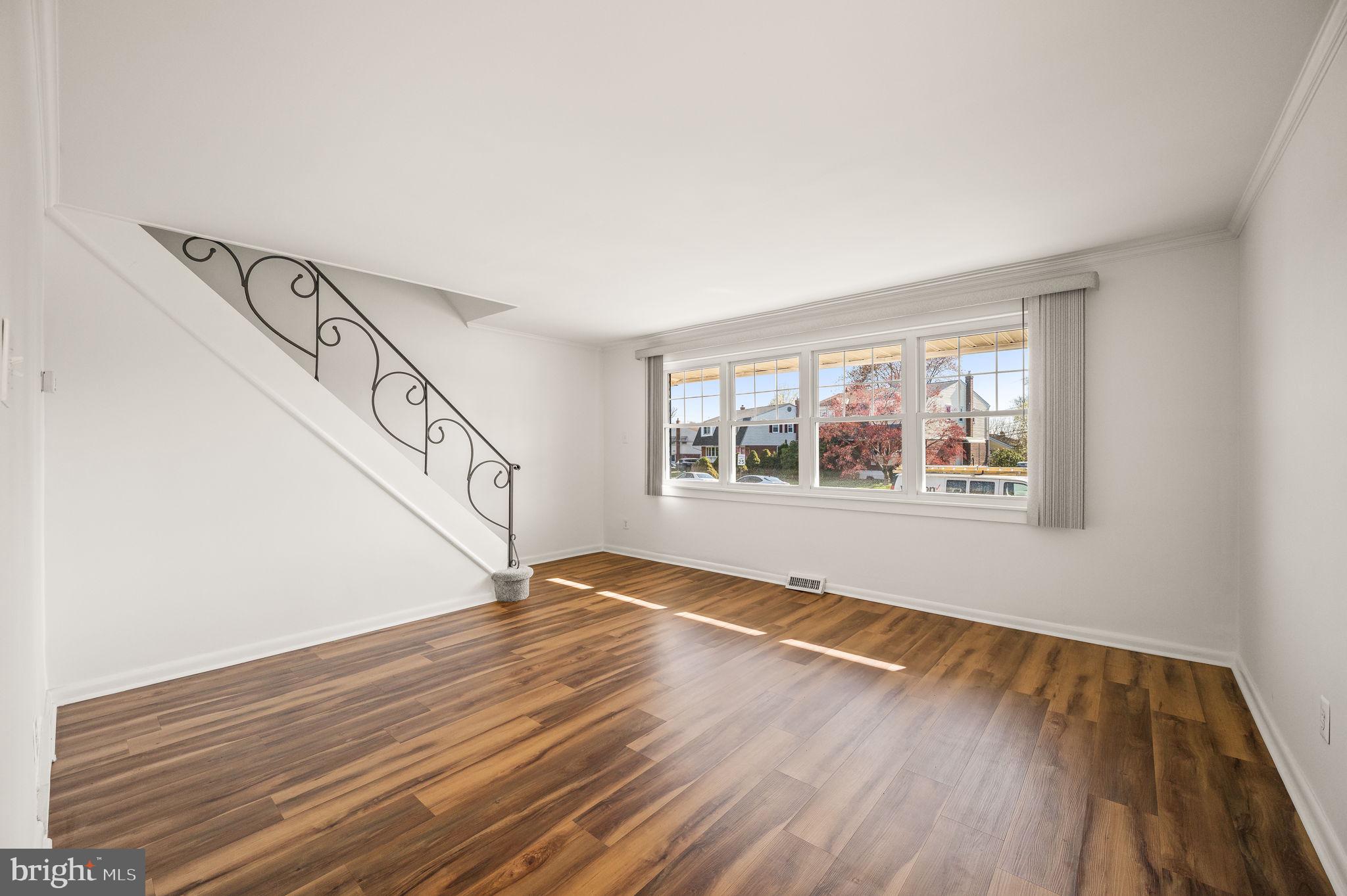 1565 Parklane Road Swarthmore, PA 19081 - Photo 5 of 28 a view of an empty room with wooden floor and a window