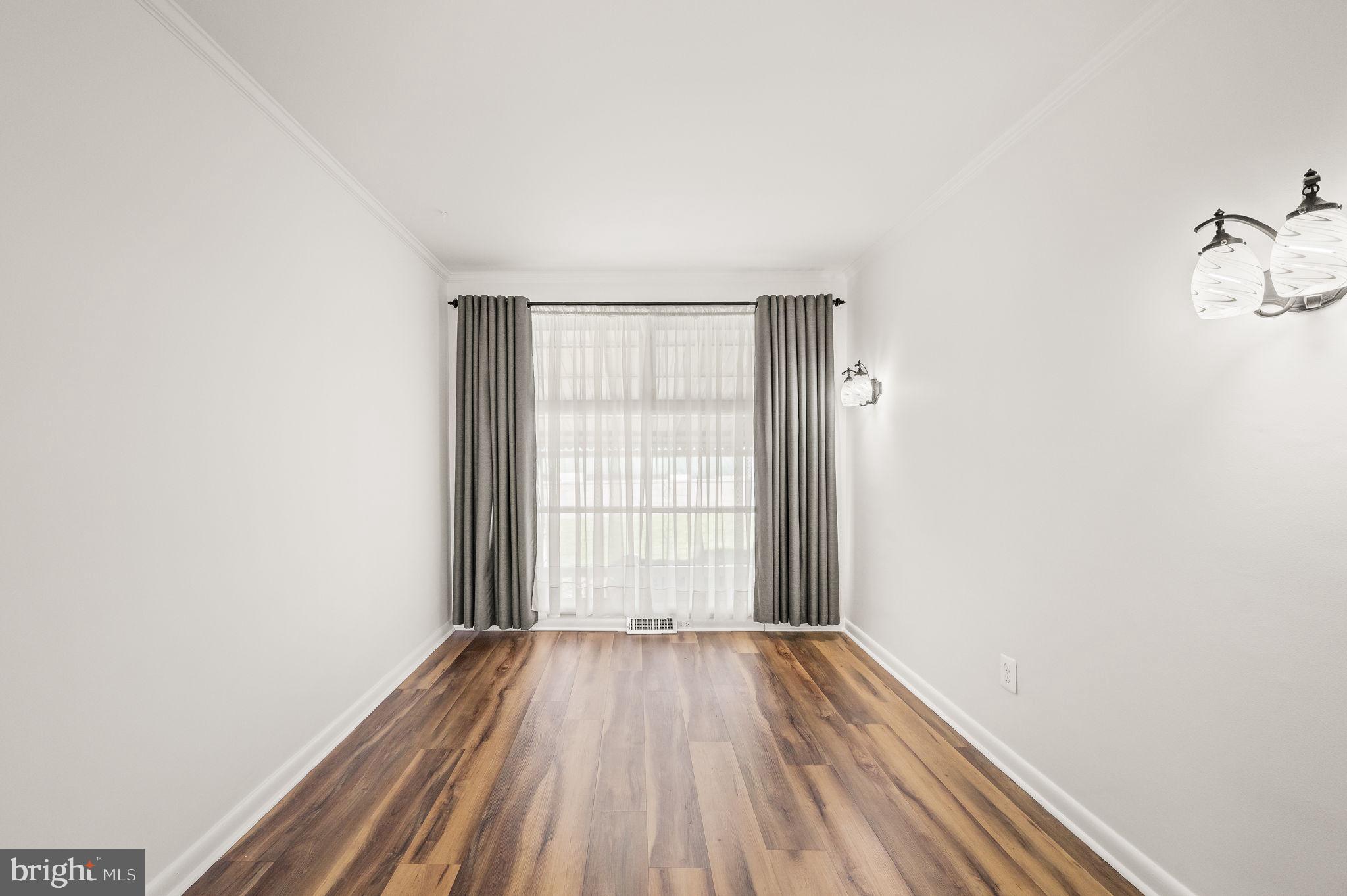 1565 Parklane Road Swarthmore, PA 19081 - Photo 8 of 28 an empty room with wooden floor and windows