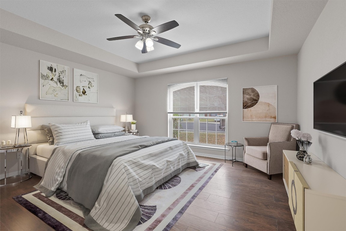 154 Meadowlark Circle Georgetown, TX 78626 - Photo 11 of 29 a spacious bedroom with a bed a couch and a flat tv screen on the dresser