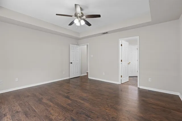 a view of an empty room with wooden floor