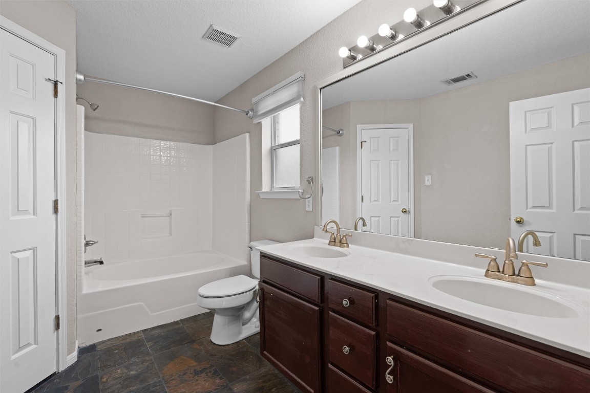 154 Meadowlark Circle Georgetown, TX 78626 - Photo 13 of 29 a bathroom with a sink double vanity granite tub and a mirror
