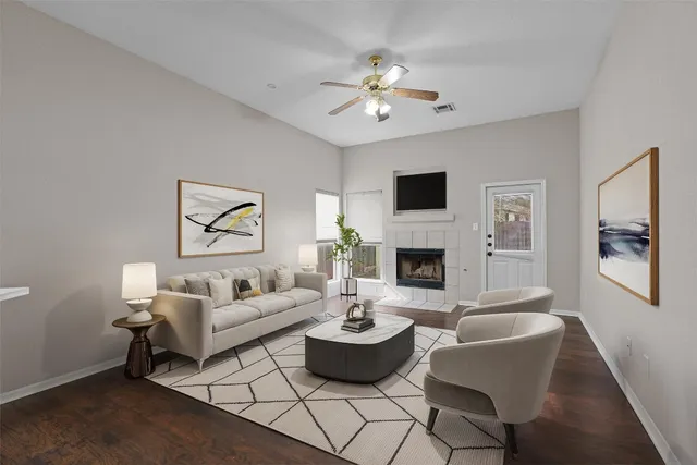 a living room with furniture chandelier and a fireplace