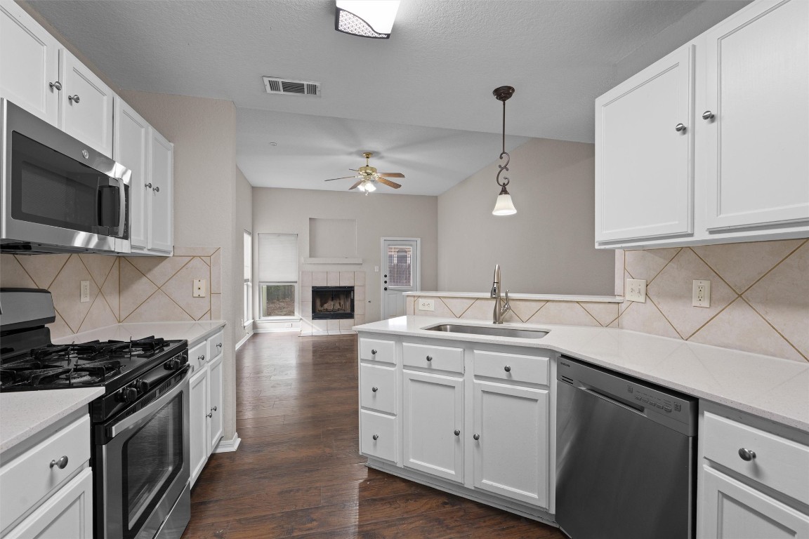 154 Meadowlark Circle Georgetown, TX 78626 - Photo 10 of 29 a kitchen with a sink stove and microwave