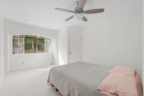 a bedroom with a large bed and a window