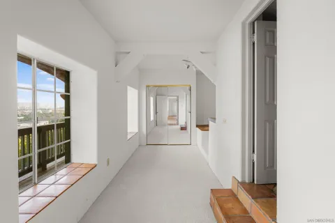 a view of a hallway with windows and entryway