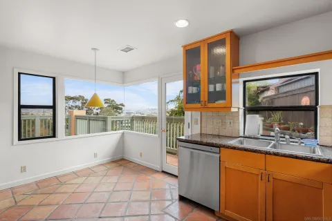 a kitchen with granite countertop a stove and a sink