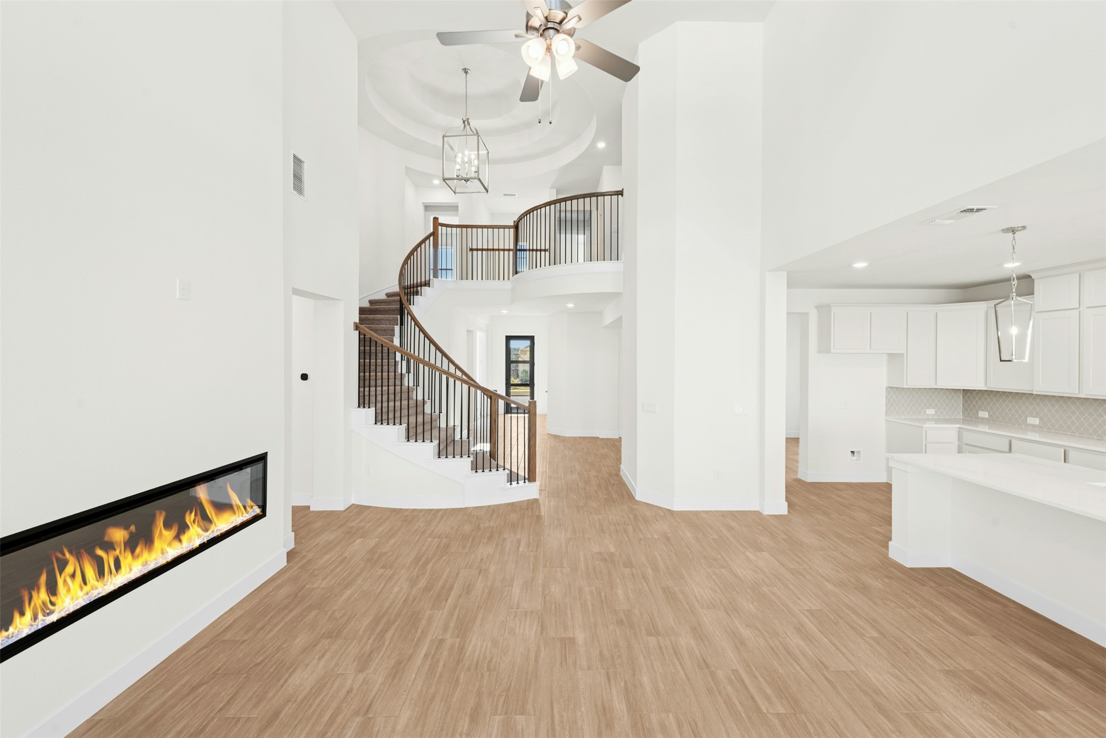 1520 Rodeo Ridge Drive Georgetown, TX 78628 - Photo 1 of 29 Unfurnished living room with light wood-style floors, a glass covered fireplace, a chandelier, a ceiling fan, and stairs
