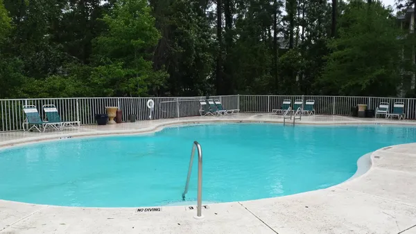 a view of a backyard with swimming pool