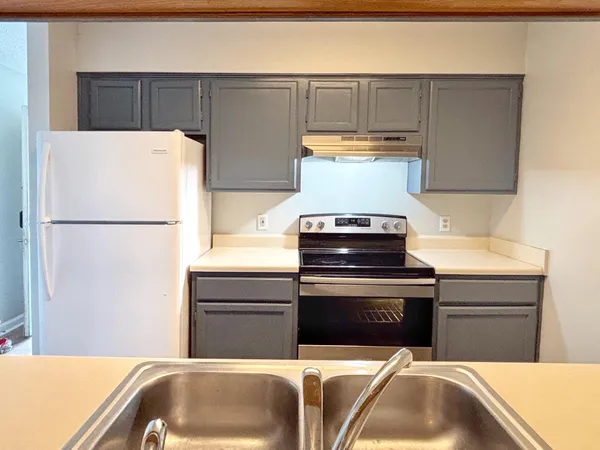 a kitchen with a refrigerator and a sink