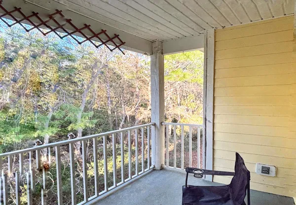 a view of a chair and table in the balcony