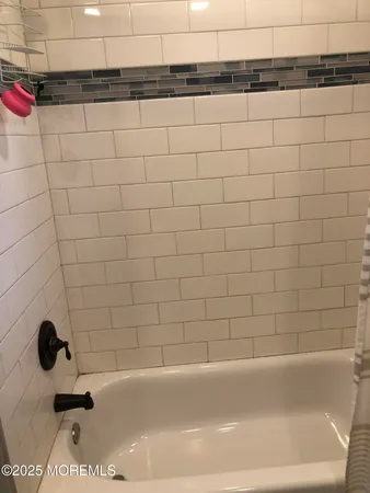 a bathroom with a glass shower door