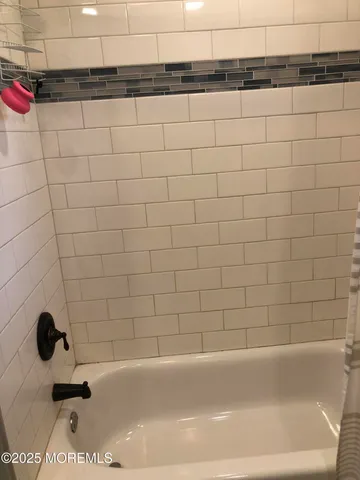 a bathroom with a glass shower door